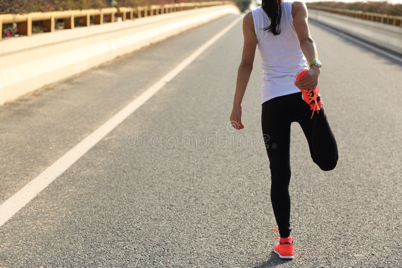 Young fitness woman runner stretching legs before run. Determined jogger stock images, royalty-free photos and pictures