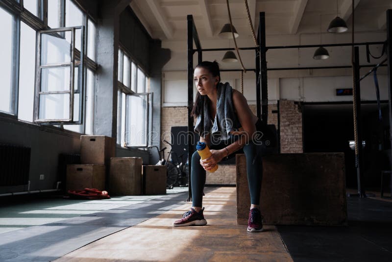 Fitness Woman Sitting On A Box At Gym After Her Workout Stock Image Fitness Woman Sitting On A Box At Gym After Her Workout Stock Image