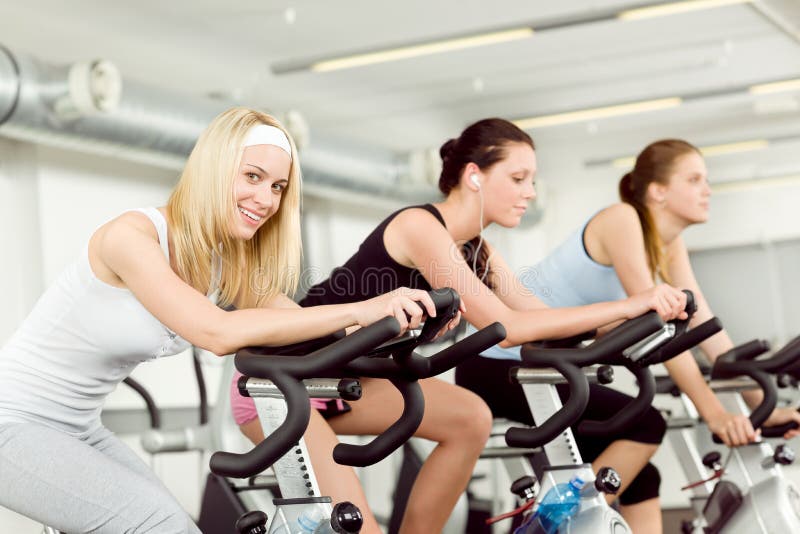 Fitness young woman on gym bike spinning