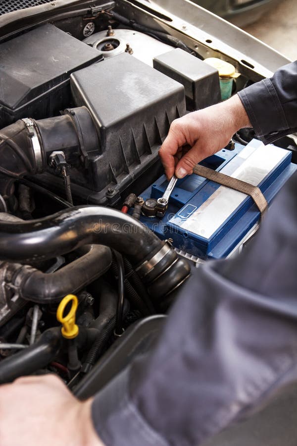 Fitting a battery to a car stock photo. Image of repair 54665070