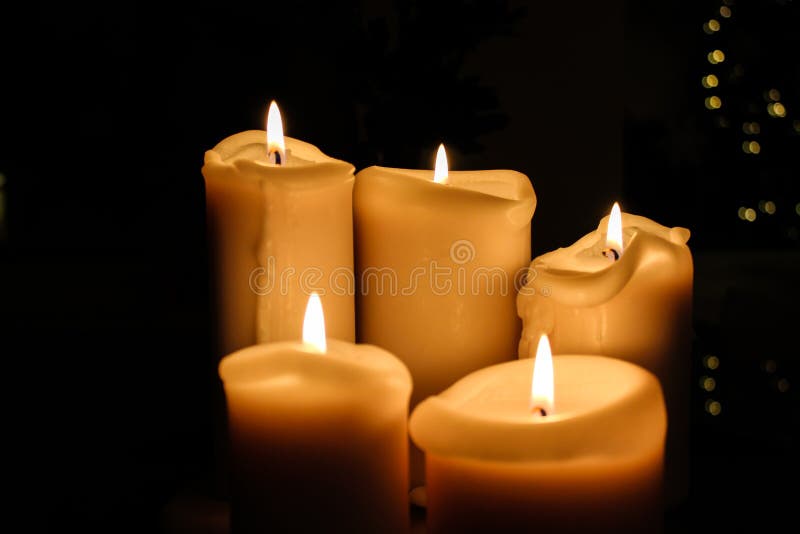 Five candles burning in the darkness