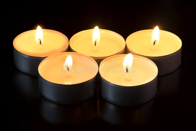 Five candles glowing in the dark