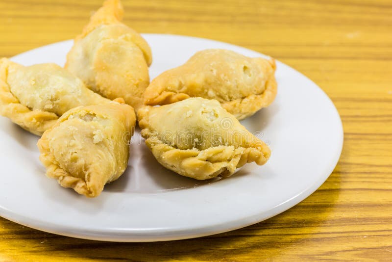 Five curry puffs on white plate stock images