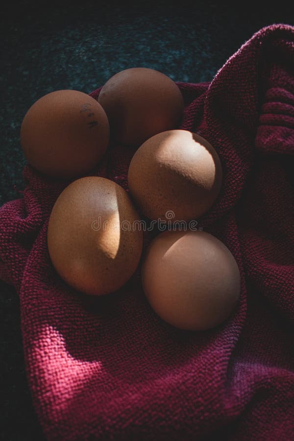 Five Perfectly Unpeeled Boiled Eggs in a Red Kitchen Towel Unpeeled