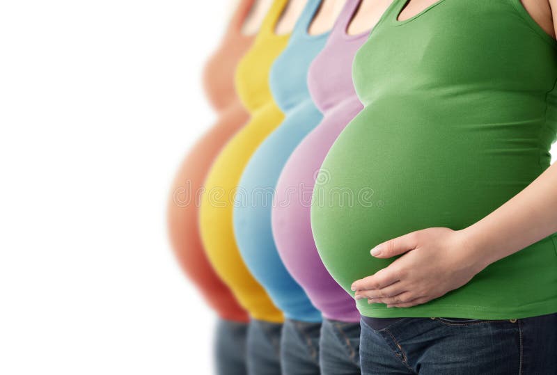 Five pregnant women standing in a row.