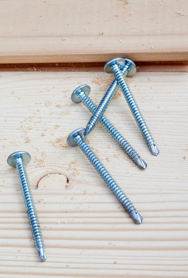 Five screws on wood planks