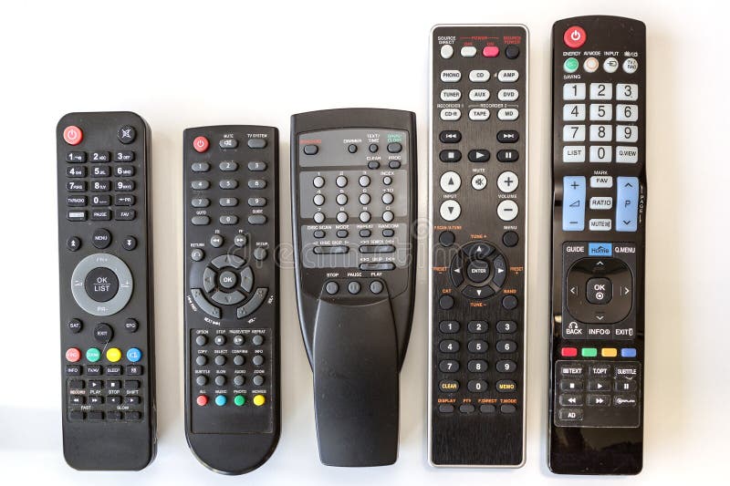 Five Used Remote Controls on White Background