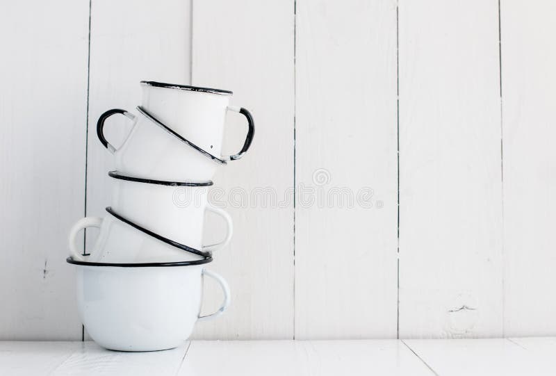 Five white enameled mugs