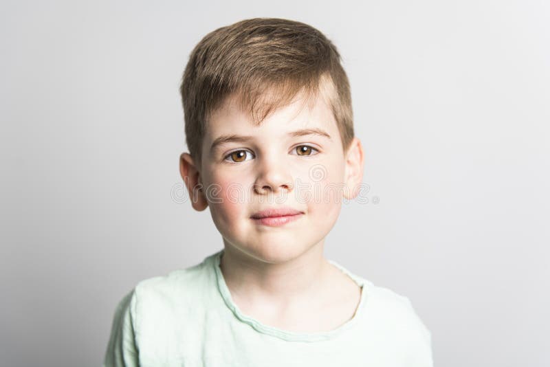 Five year old boy posing over white studio background royalty free stock photo