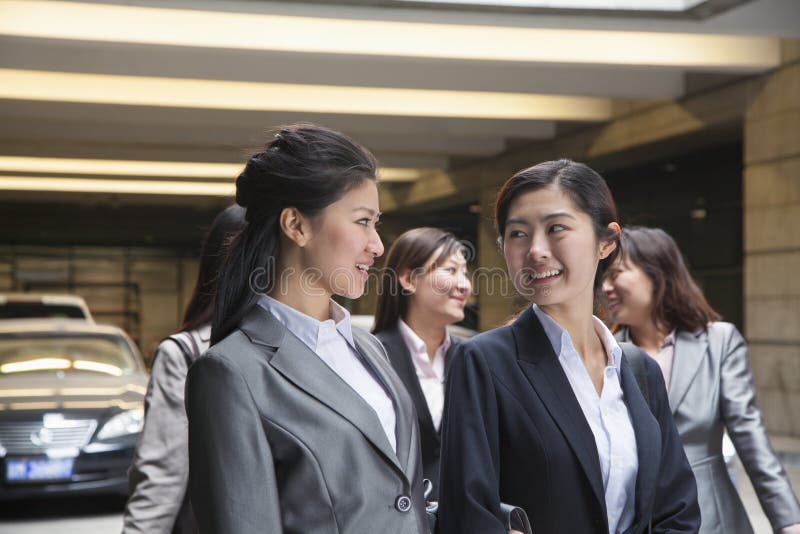 Five young Businesswomen talking and smiling in the parking garage royalty free stock photo