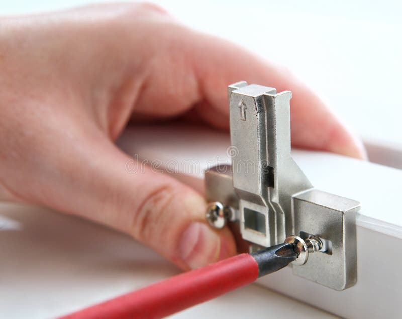 Fixing furniture hinges, using, a Phillips screwdriver. stock photos Fixing furniture hinges, using, a Phillips screwdriver. stock photos
