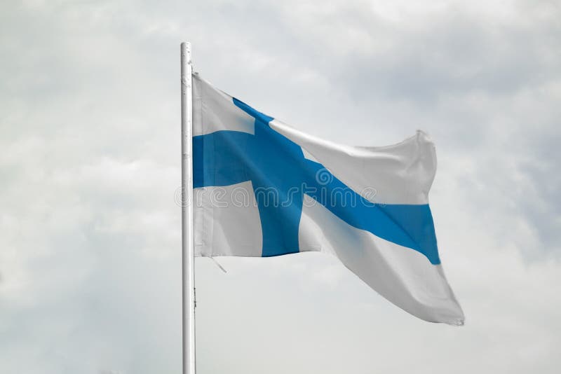 Flag of Finland on a blue sky with clouds background stock images Flag of Finland on a blue sky with clouds background stock images