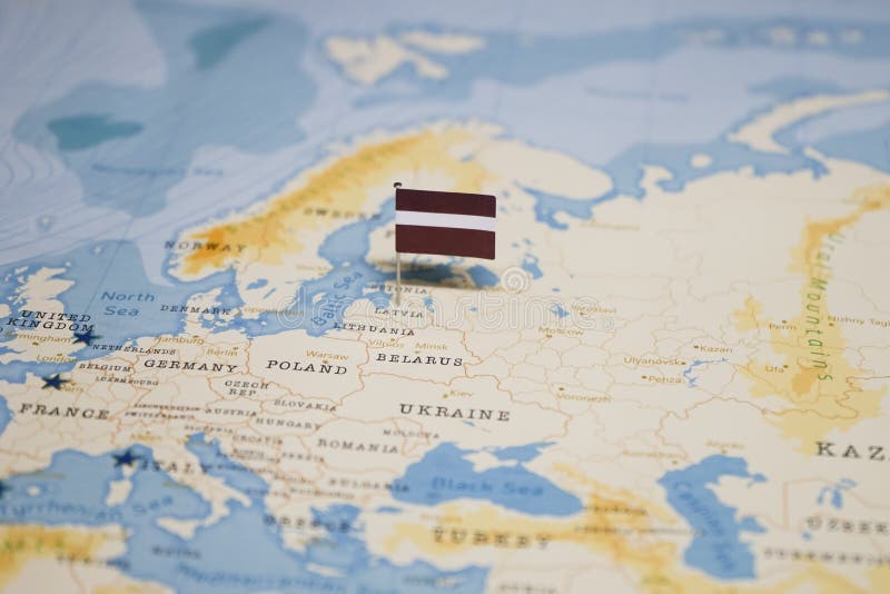 The Flag of latvia in the world map royalty free stock photo