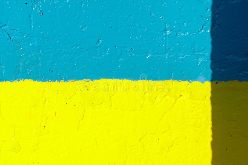 The Flag of Ukraine on the Fence. the Surface of the Concrete Fence is
