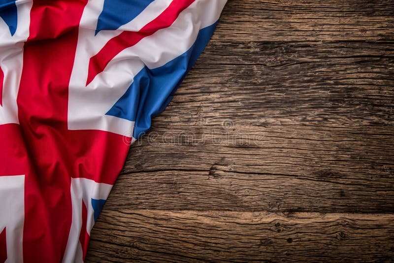 Flag of UK on old wooden background. Union Jack flag on old oak background. Flag of UK on old wooden background. Union Jack flag on old oak background.