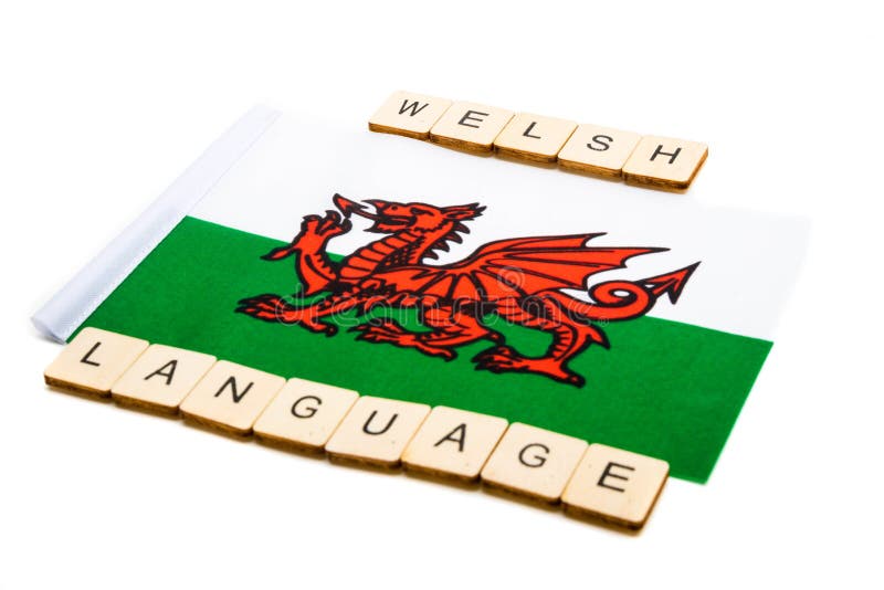 The national flag of Wales on a white background with a sign reading Welsh Language. The national flag of Wales on a white background with a sign reading Welsh Language