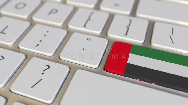 Key with flag of the United Arab Emirates UAE on the computer keyboard switches to key with flag of Great Britain