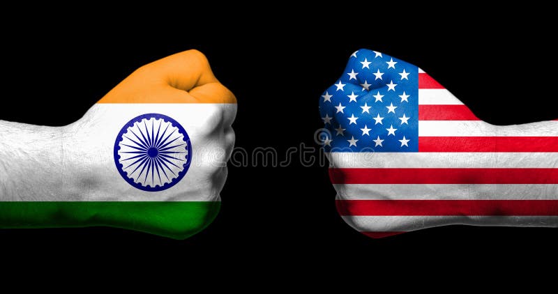 Flags of India and United States painted on two clenched fists facing each other on black background/India - USA tariff conflict concept.