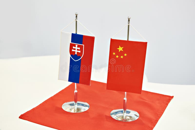 Flags of Slovakia and China on table