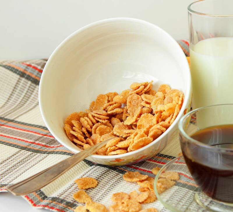 Flakes in a Deep Plate, Cup of Coffee and Orange, Sliced Stock Image
