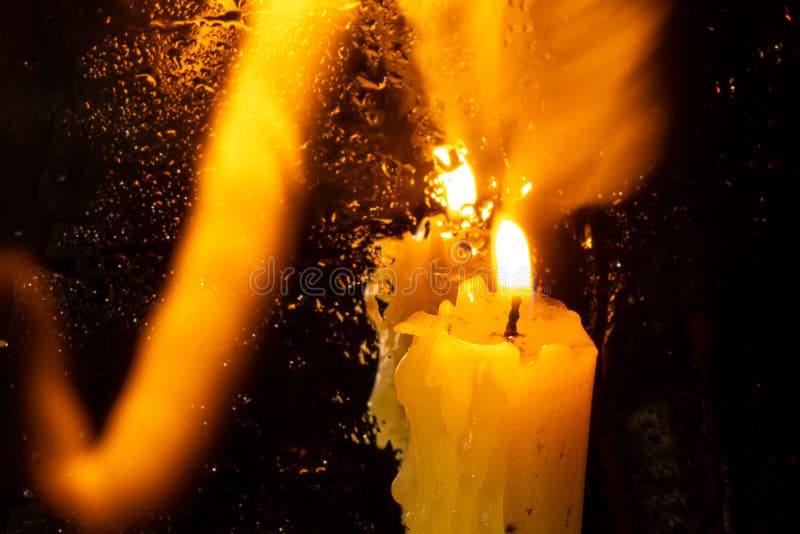 The Flame of a Church Candle in a Dark Room Closeup Stock Photo
