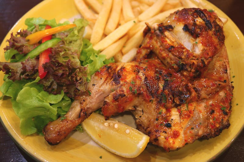 Flame Grilled Spicy Chicken with Chips and Fresh Salad Stock Image
