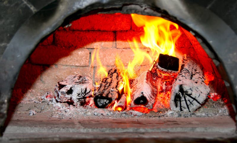 Flaming wood in old brick fireplace