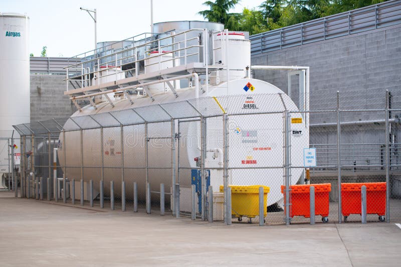 Flammable white industrial container. Hillsboro, OR / USA - July 9 2018: Flammable huge industrial diesel container storage royalty free stock image Flammable white industrial container. Hillsboro, OR / USA - July 9 2018: Flammable huge industrial diesel container storage royalty free stock image