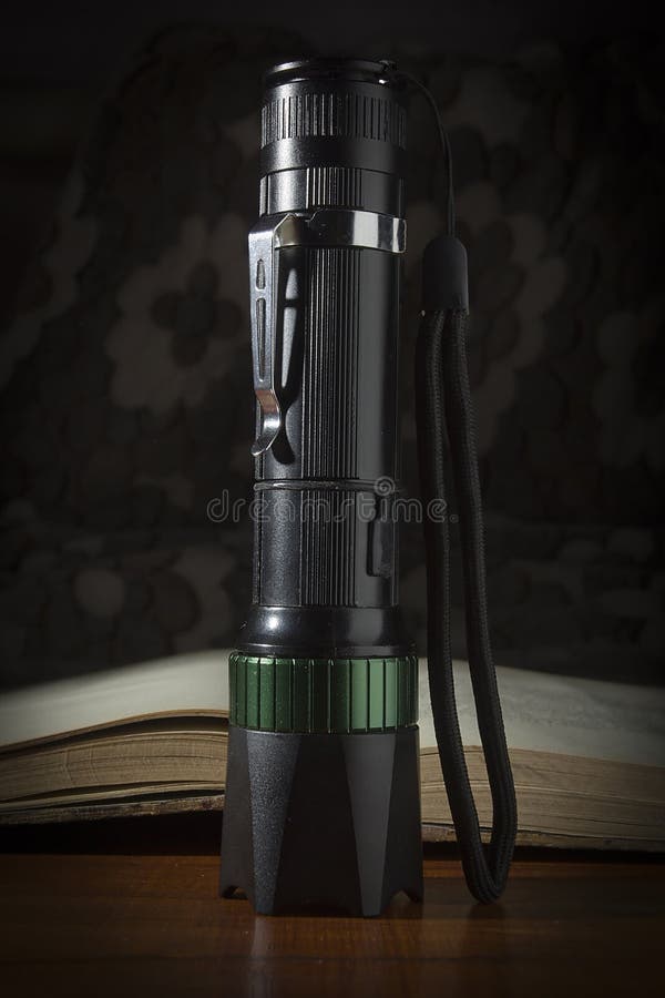 Flashlight and book stock image. Image of lamplight 167530489