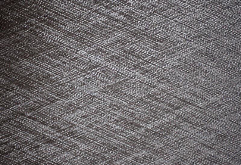 A Flat Black Metal Surface with Sanding Marks Forming a Diagonal