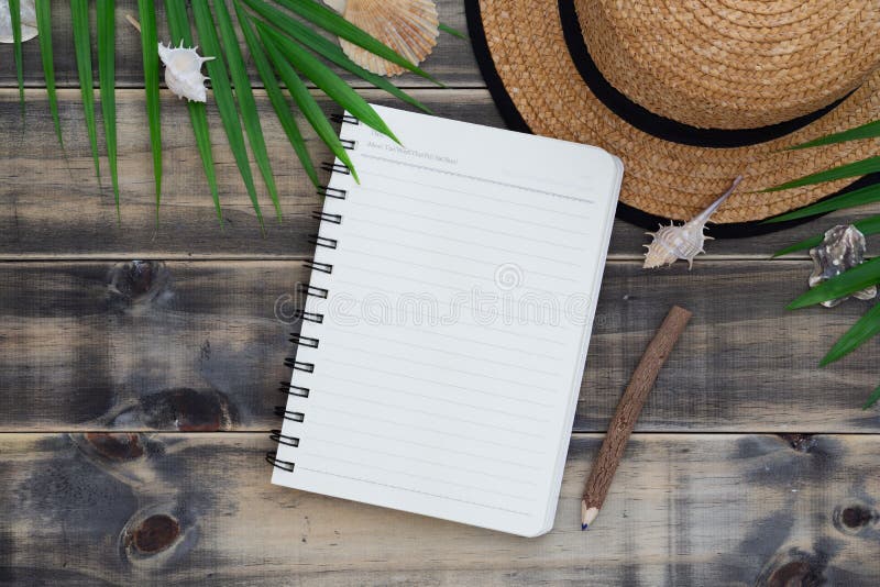 Flat lay with beach hat, sea shells, palm leaves and blank notebook and pencil. Holiday tropical beach travel vacation concept. Top view with copy space for your text background creative decoration design desk diary empty fashion green hipster journey leaf lifestyle natural nature notepad object paper retro set summer table tourism tourist traveler trip vintage white wood wooden