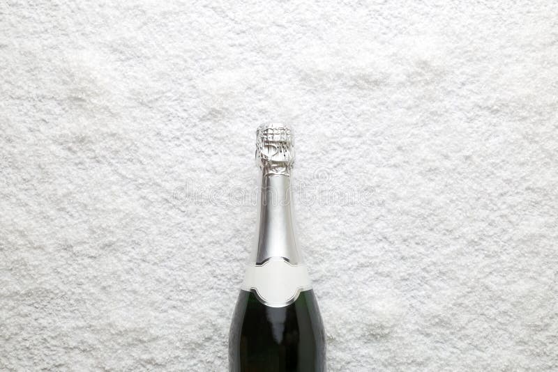 Flat Lay of Champagne Bottle and Five Paper Stars on Yellow Background