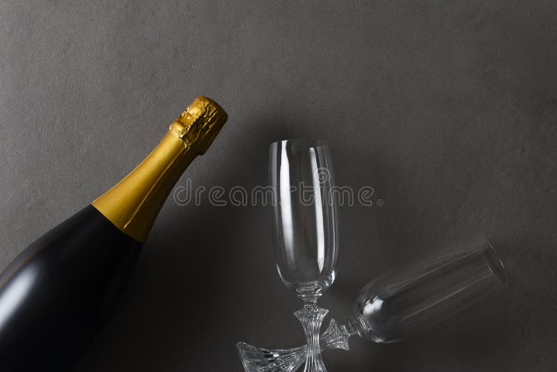 Flat Lay Champagne and Two Glasses on a Dark Gray Table Stock Photo