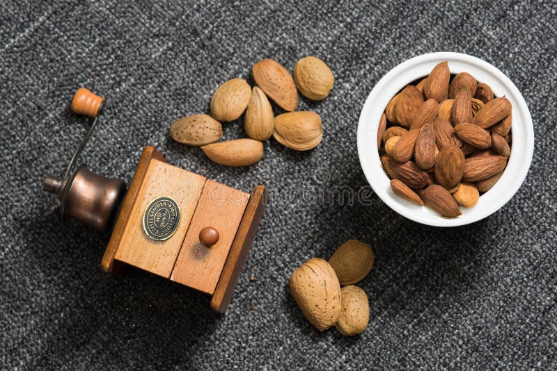 https://thumbs.dreamstime.com/b/flat-lay-composition-antique-coffee-grinder-nuts-peeled-almonds-grey-fabric-texture-146644545.jpg