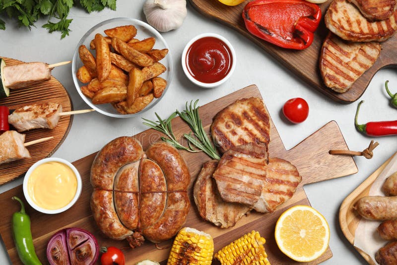 Flat Lay Composition with Barbecued Meat and Vegetables on Table Stock