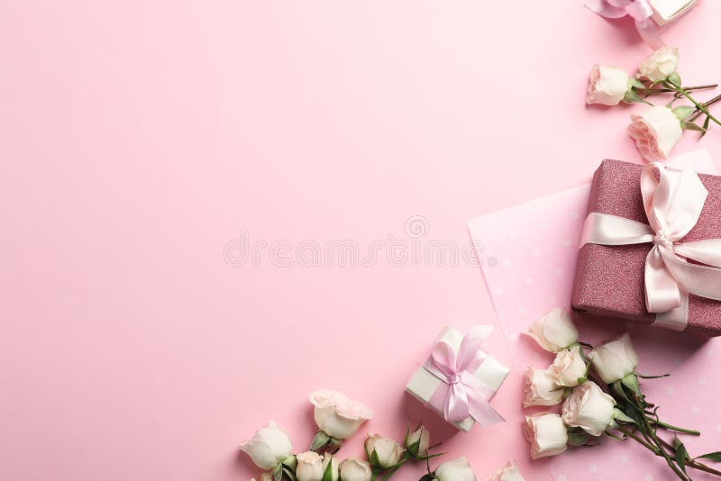 Flat Lay Composition with Beautiful Roses and Gift Boxes on Color