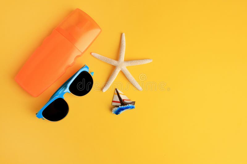 Flat lay composition with bottle of sunscreen on yellow background. Space for text royalty free stock images