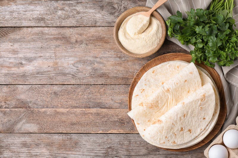 Flat Lay Composition with Corn Tortillas on Wooden Background