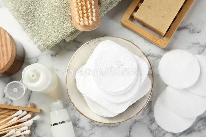Flat lay composition with cotton pads on light marble table stock images