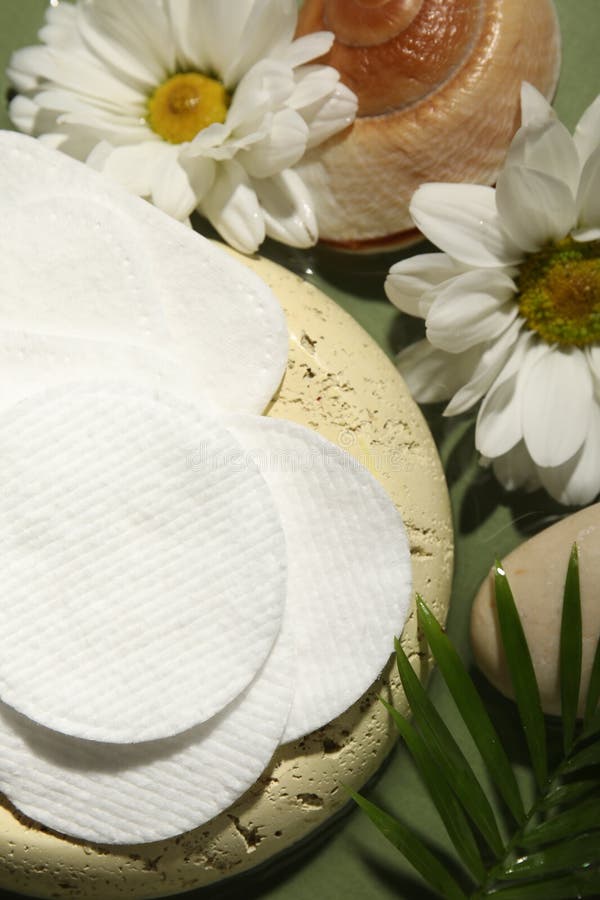 Flat lay composition with cotton pads on green table royalty free stock photography