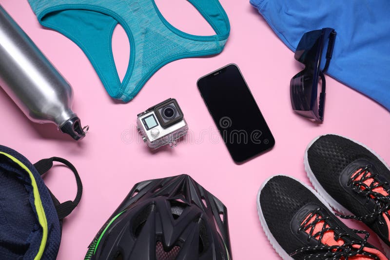 Flat lay composition with cycling accessories on pink background stock image