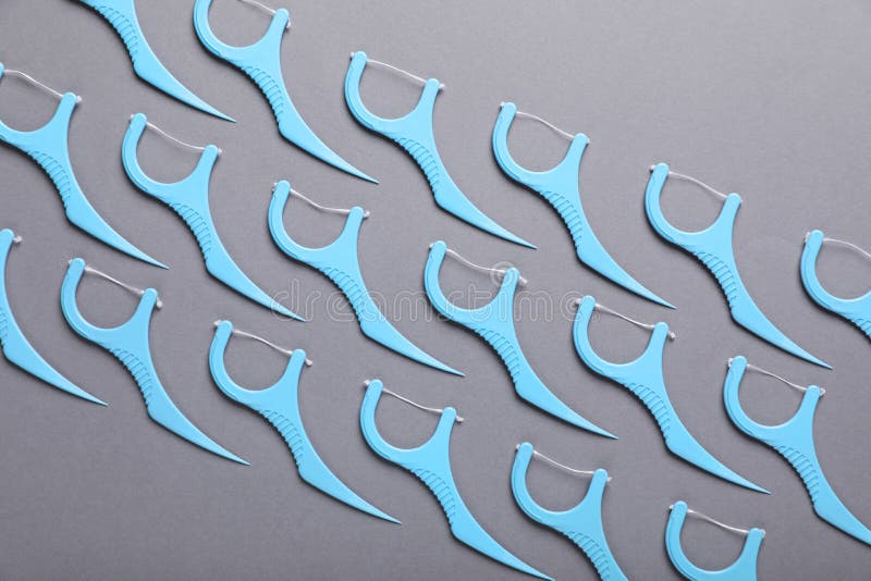 Flat Lay Composition with Dental Floss Picks on Grey Background Stock