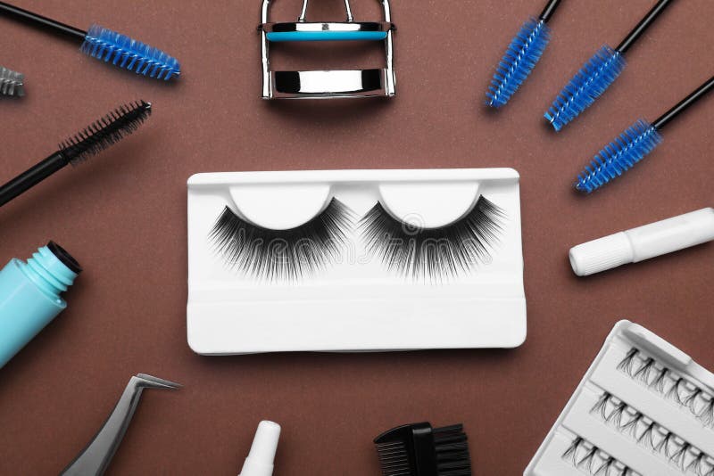 Flat Lay Composition with Fake Eyelashes, Brushes and Tools on Brown