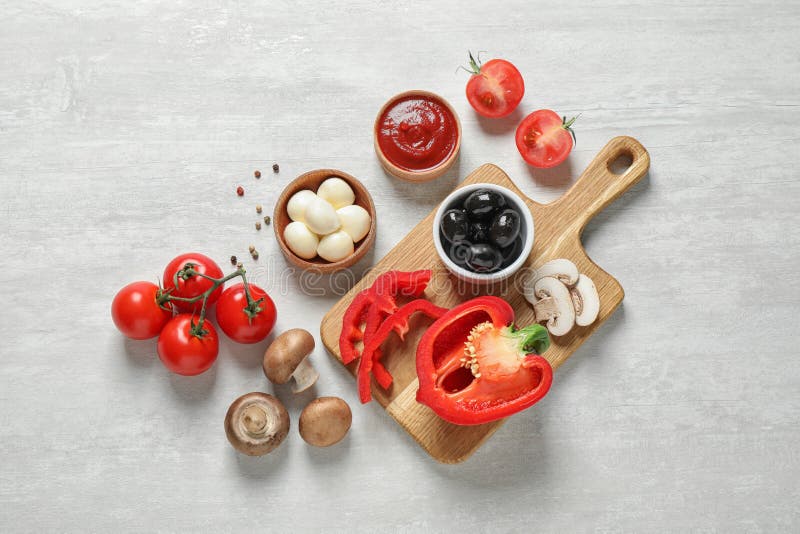 Flat composition with fresh ingredients for pizza on white wooden table royalty free stock image