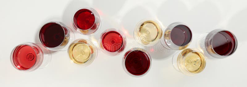 Flat lay composition. Glasses with different wine on white background