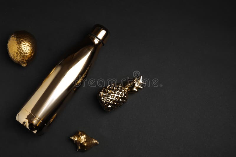 Flat Lay Composition with Gold Bottle, Decorative Pineapple, Lemon and
