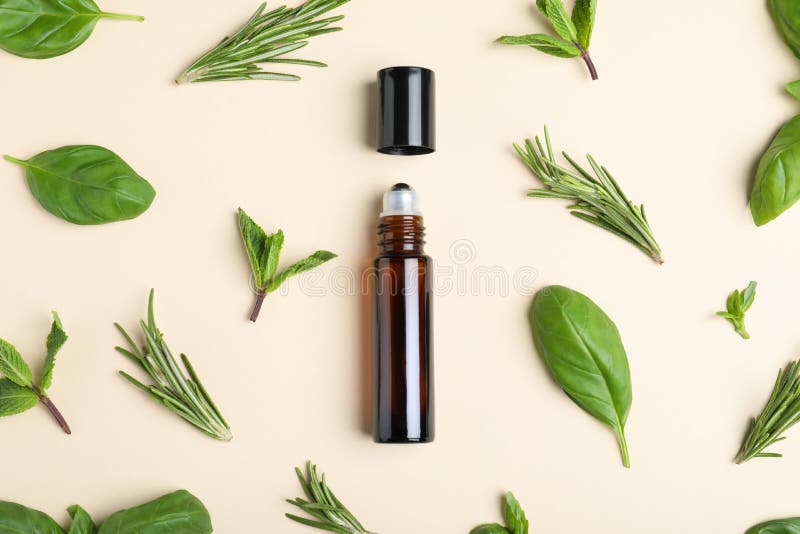 Flat lay composition with herbal essential oil. On beige background stock photography
