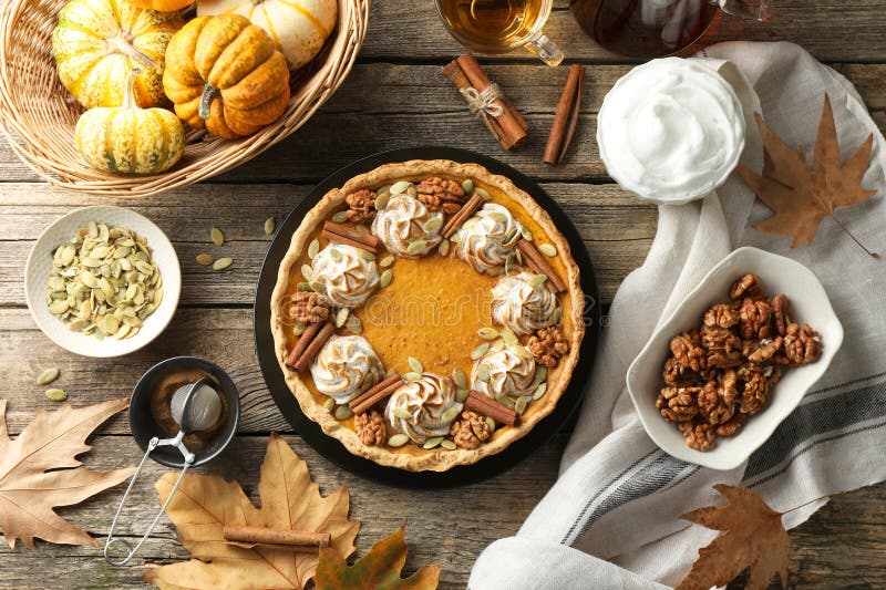 Flat lay composition with homemade pumpkin pie on wooden table royalty free stock images
