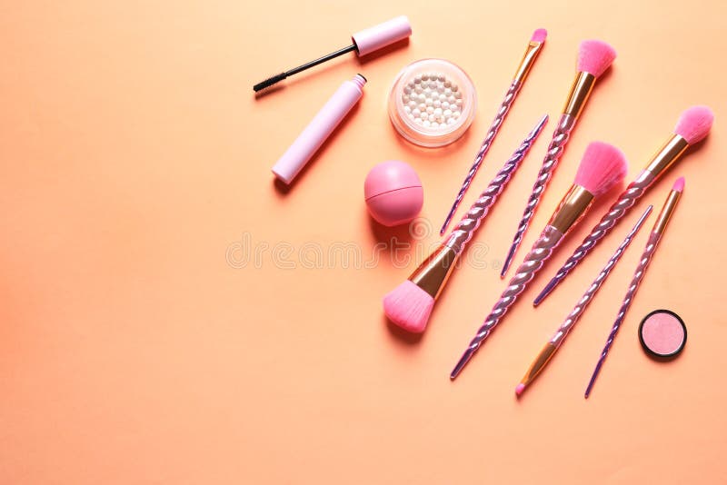 Flat Lay Composition with Makeup Brushes on Orange Background Stock