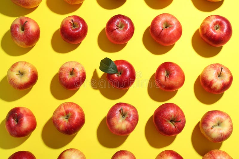 Flat lay composition with many red apples on yellow background stock image